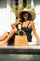 Model sitting next to Jenn Lee Santorini Bag