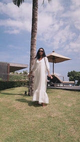 Model wearing white maxi dress, black sunglasses, and Jenn Lee Flores Crossbody