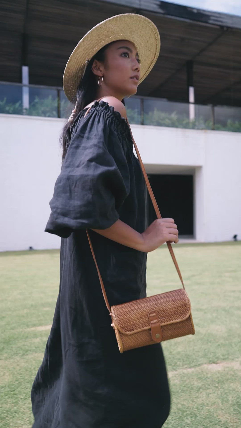 Model wearing straw hat, black dress, and Jenn Lee Bidadari Crossbody
