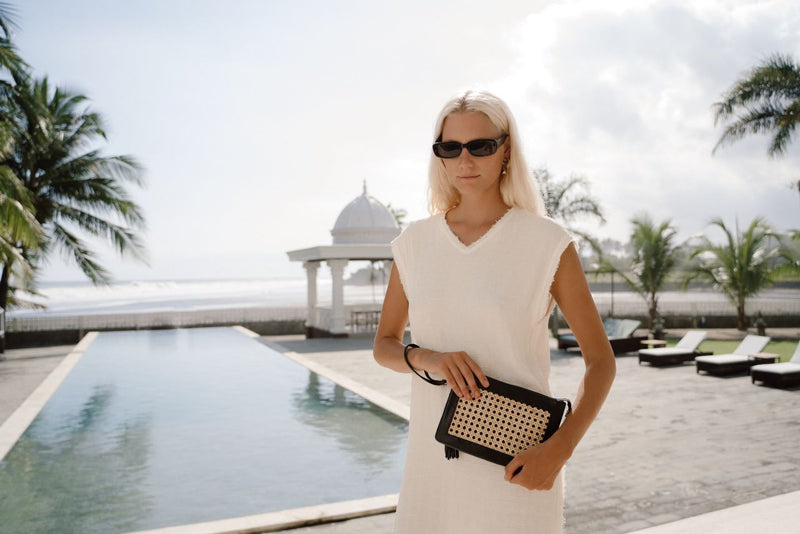 Model holding Jenn Lee Pisa 3-in-1 Bag as clutch