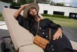 Model wearing straw hat, black dress, and Jenn Lee Bidadari Crossbody
