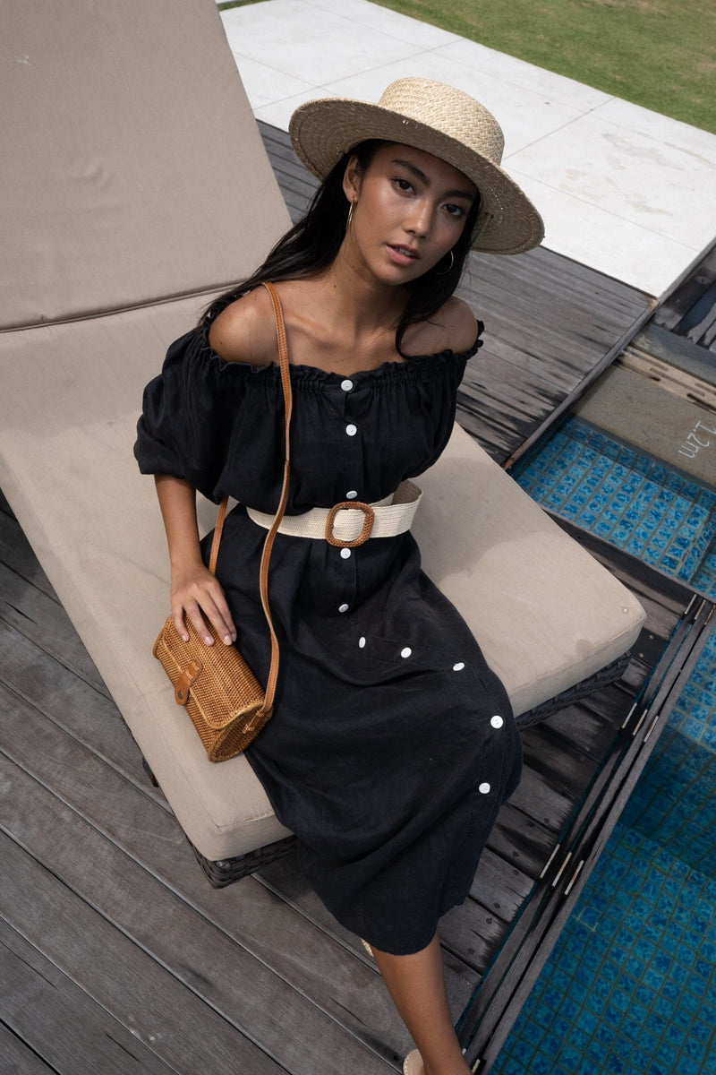 Model wearing straw hat, black dress, and Jenn Lee Bidadari Crossbody