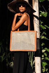 Model wearing straw hat, sunglasses, black maxi dress, and holding Jenn Lee Punta Mita Tote