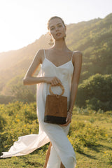 Model wearing white maxi dress holding Jenn Lee St. Barth Box Bag